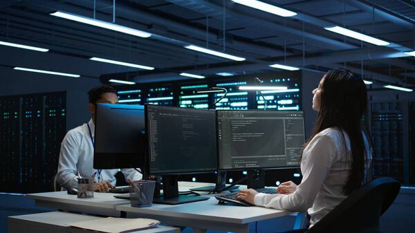 Engineer using augmented reality tech in data center, installing software, troubleshooting issues. IT expert in server hub looks at AR hologram, establishing performance benchmarks, camera B