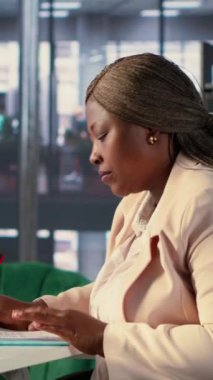 Vertical Video Corporate lideri, çıkış taleplerini ve üretkenlik için diğer belgeleri onaylamak üzere iş sözleşmeleri ve anlaşmalar imzalıyor. Afrikalı Amerikan CEO 'su hukuk yönetimi ve başarı öyküsü üzerinde çalışıyor.