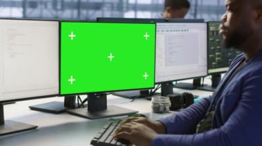 Sunucu odasında yeşil ekran bilgisayar kullanan bir mühendis en az arayı sağlayacak felaket kurtarma planları geliştiriyor. Veri merkezi çalışanı Model PC 'ye bakıyor, performansı izliyor, kamera A