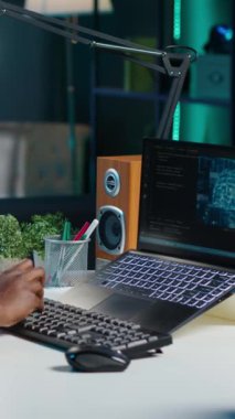 Dikey video Yapay Zeka uzmanı Java programlama dillerini kullanarak daire ofisindeki dizüstü bilgisayara kod yazar. Yapay zeka programcısı veri tabanı hatalarını düzeltirken uzaktan çalışıyor