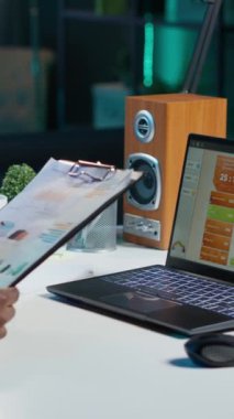 Dikey Videolu Öz, dizüstü bilgisayardaki istatistiksel veri finans grafiklerini kontrol eden, görüşleri araştıran bir kadın. İşletme grafiksel ekonomik rakamlarını karşılaştıran uzaktan çalışan, strateji yapan, kamera