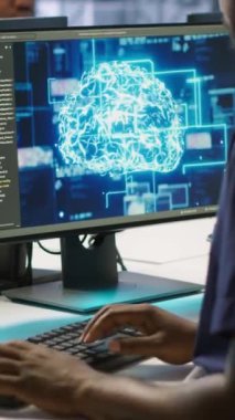 Veri merkezindeki dikey video Afrikalı Amerikalı işçi gelişmiş yapay zeka öngörü bakım sistemleri uyguluyor. Donanım arızalarını tespit etmek için yapay zeka kullanan mühendis