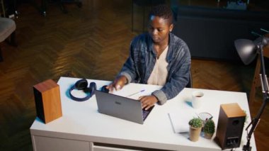 Daire ofisine gelen bir kadın, masa başında oturuyor, dizüstü bilgisayarını açıp görevlerini yapmaya başlıyor. Teleworker iş vardiyasına evde başlıyor, not defteri aygıtı hazırlıyor, çevrimiçi giriş yapıyor, kamera B