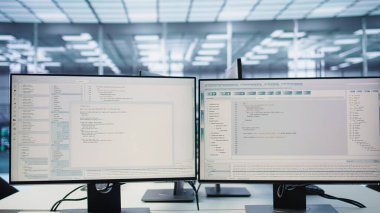 Computers in empty data center facility managing rackmounts energy consumption. Close up of script on PC monitors used for automation and monitoring processes in server room, panning shot clipart