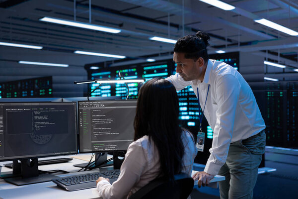 System administrators in data center running system diagnostic tests on PC to fix problems. IT experts deploying and error checking utilities on computers to repair network issues in server rigs