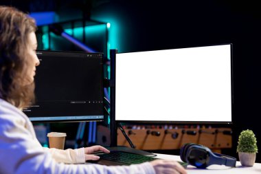 Freelancing admin using isolated screen computer monitors to filter malicious traffic from cybercriminals attempting to corrupt company data. IT specialist in apartment working on mockup desktop PC clipart