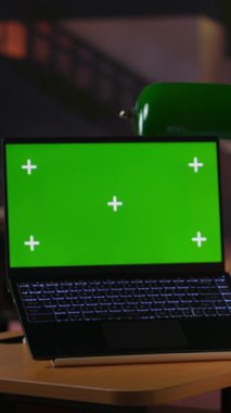 Dikey video odaklı liseli kız kütüphanede yeşil ekranlı akademik görevlere katılıyor, okul ödevlerini laptopuyla yapıyor. Sınıf çalışması görevleri çözülüyor, İnternet üzerinden bilgi arıyor