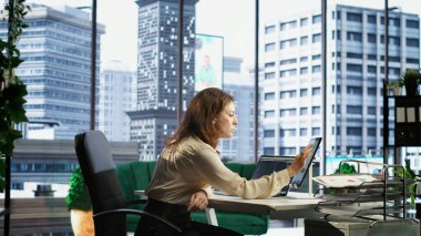 Liderlik becerilerine sahip iş kadını, analiz, öngörü ve pazar koşulları içinde örgütsel istikrarın sağlanması konularındaki uzmanlığını gösteren bir mali rapor hazırlıyor. Kamera B.