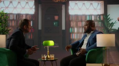 Yeni bir ortaklık kurmak için el sıkışan iki milyarder servetlerini ikiye katlayacak bir anlaşma yaptılar. Üst sınıf sosyete üyeleri işbirliği için pazarlık ediyorlar. Kamera A.