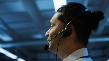 Data center agent providing logistics support in workspace, overseeing equipment rackmounts. Close up shot of server hub staff member communicating with repairmen, camera A clipart