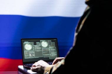 Russian soldier using military tech on laptop to identify threats from enemies. Russia ex KGB FSB personnel using software on notebook device to relay info to war front lines clipart