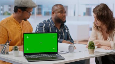 Emlakçı ekibi ofis düzenini kopyalama alanının yanında sunuyor. Müşteriyle birlikte planları inceliyorlar. Emlakçılar kira kontratı ve kira sözleşmesi için çalışıyorlar. Kamera B.