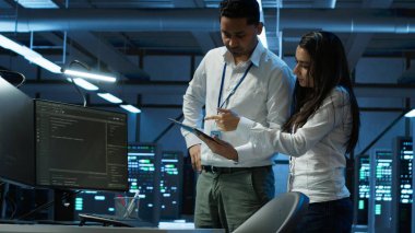 Yüksek teknoloji veri merkezindeki programcılar tablet kullanarak sorun çözüyorlar. Sunucu çiftliğinde çalışan takım arkadaşları aygıt kullanarak, performans kriterleri oluşturarak, kamera A