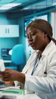 Önlüklü erkek ve kadın hemşireler uzman doktorlarla profesyonel eğitim ve araştırma içindeler. Sıhhiye onlara ilaç ve ilaç stoğu sunuyor. Kamera B