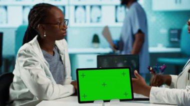 Afro-Amerikan doktor, krom anahtarla profesyonel ofiste bir konsültasyon yürütüyor. Teşhis raporlarını analiz ediyor ve hastanın sağlığı hakkında danışmanlık yapıyor. Kız sağlıkçıdan tavsiye alır. Kamera A.