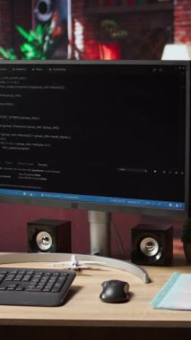 Dikey video programlama dili düzenleyici yazılım UI ev çalışma alanında bilgisayar ekranı, flok aşağı çekim. Dijital yazılım uygulamalarını çalıştırmak için kullanılan PC monitöründe gösterilen kod satırları