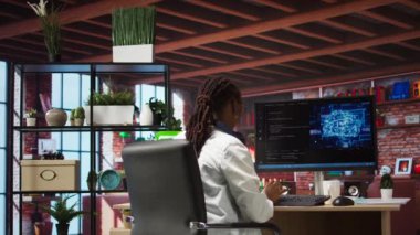 Kendi kendini öğrenme algoritmaları aracılığıyla yapay zeka hesaplaması için bilgisayar kullanan bir programcı. Masaüstü bilgisayarı, kamera üzerinde yapay zeka ile çalışan uzak bir çalışan. Geniş açılı bir görüntü.