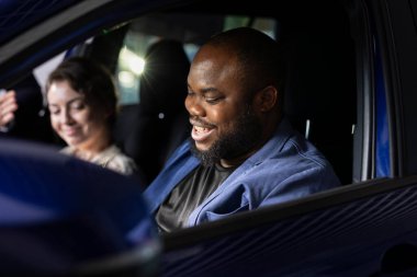 Test sürüşünden sonra araba almaya karar veren memnun bir adam, sürüş aracının keyfini çıkarıyor. Mutlu Afro-Amerikan müşteri ihtiyaçları için doğru olduğunu anladıktan sonra yeni bir araba almak için heyecanlanıyor.