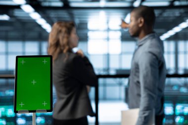 Güç yönetimi ayarlarını ayarlayan veri merkezindeki krom anahtar tableti ve takım çalışması programcılarını kapat. Bulanık arkaplanda teknisyenlerin önünde izole ekran modelleme aygıtı