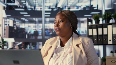 Hırslı CEO 'nun kendi ofisinde dinlenmesi ve şehir merkezinin penceresinden dışarı bakması. Girişimci lider koltuğunda dinleniyor, başarı öyküsü. Kamera B.