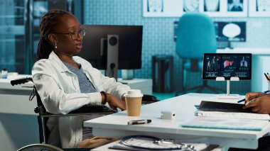 Afrika kökenli Amerikalı doktor ve hasta detaylı bir sağlık kontrolüne tabi tutuluyor, profesyonel bakım ve sağlık önlemlerini vurguluyor. Kronik bozukluk var. Kamera A.