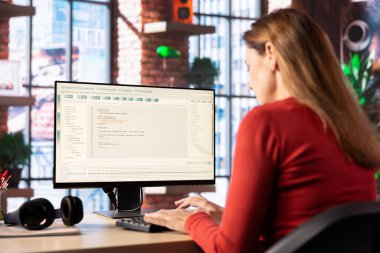 Woman typing prompts into an AI powered chat system on her computer, advanced virtual assistant showcases futuristic algorithms and smart solutions for productivity and connectivity.