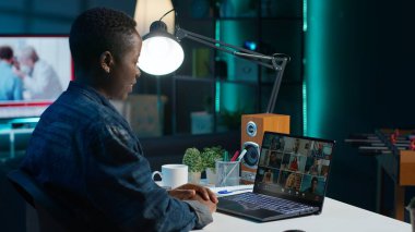 Uzaktan çalışan, proje ilerlemesi hakkında geri bildirim almak için internet video çağrısını kullanan yöneticileri arıyor. Evdeki tele-işçi telekonferans toplantısı için iş arkadaşlarından yardım istiyor. Kamera A.