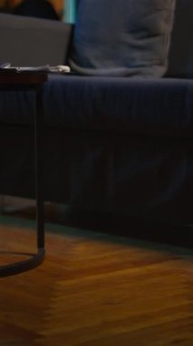 Modern dekorlu ve modaya uygun elektronik aletli dikey Video Cozy dairesi rahatlama alanı, şık bir minimalist stüdyo dairesi, akıllı bir televizyon ve kahve masası. Kapalı mekanlı rahat bir ev