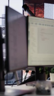 Boş IT başlangıç ofisinde uygulamaları inşa etmek için kullanılan programlama dillerini gösteren dikey video PC. Yazılım geliştirme ajansındaki bilgisayar ekranı kod gösteriyor, sağ vuruşu taşıyor