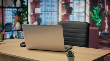 Moda mobilya ve ahşap döşeme ile dekore edilmiş serbest ve şık endüstriyel kentsel alanlar için kullanılan bir ofis masası olan boş modern stüdyo daire. Kapalı mekanlı bitkilerin olduğu en küçük stüdyo..