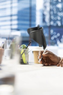 HR worker reviewing candidate, asking questions about qualifications, giving him application form. Close up of applicant writing signature on paperwork after proving enthusiasm for job opportunity clipart