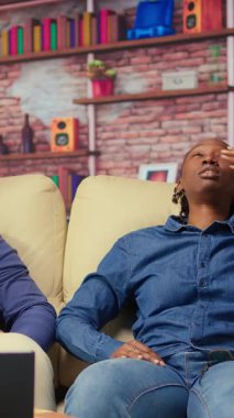 Afro-Amerikalı çift kanepeye uzanıp rahatlıyorlar, kendilerini çok yorgun hissediyorlar ve baskı altında çalışıyorlar. Uykucu insanlar yorgunluk ve iş yükleriyle uğraşıyorlar. Bağımsızlar endişeli. Kamera B.