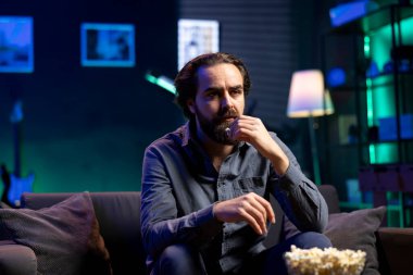 Kafası karışık bir adam yayın servisiyle ilgili kafa karıştırıcı bir film izlerken patlamış mısır yiyor, işten izin almanın keyfini çıkarıyor. Abur cubur yiyen, TV 'de yayınlanan filmlere karışık senaryolarla bakan insanlar.