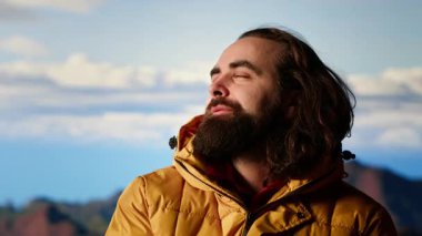 Genç yetişkin gezgin çadırı ile dağın tepesinde kamp kuruyor. Aşırı soğuk rüzgarlarla savaşıyor. Rüzgarlı ve güzel manzaralı bir yer. Nefes kesici kamp alanı, seyahat tutkusu. Kamera B.