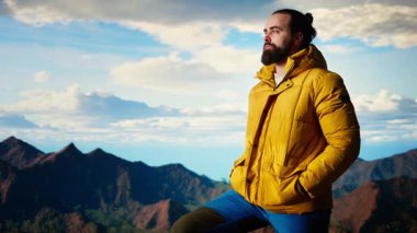 Gururlu mutlu kâşif dağ zirvesine tırmanmaktan memnun, farkındalığın ve kararlılığın tadını çıkarıyor. Genç yetişkin vahşi doğa ve destansı manzara hakkında tutkulu oluyor. Kamera A.