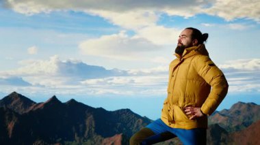 Yürüyüşçü, tepedeki panoramik dağ manzarasına, sonsuz gökyüzüne ve engebeli tepelere hayran olmak için durup zihinsel berraklık için nefes kesici bir zemin oluşturur. Maceraperest. Kamera B.