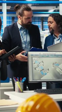 Fotovoltaik fabrikasındaki dikey video mühendisleri arızalı sistemleri teşhis ettikten sonra beşlik çakıyorlar. Güneş panelleri imalat fabrika işçileri başarıyla azaltılmasını kutluyor