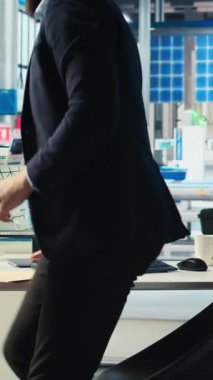 Dikey video Photovoltaics fabrika müdürü güneş mühendisliği ekibiyle çalışıyor, beyin fırtınası yapıyor, sistemlerin güvenilirliğini artırıyor. Güneş paneli üretim tesisi uzmanı geri bildirim sağlıyor