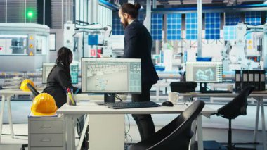 Fotovoltaik fabrika müdürü, güneş pilleri tasarımlarını 3 boyutlu yazılım araçlarıyla görselleştirdikten sonra not alıyor. Güneş panelleri bitki teknisyeni CAD programında bilgisayar simülasyonları yaptıktan sonra şemalar çizer