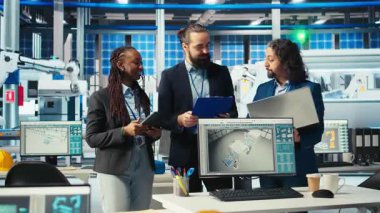 Fotovoltaik fabrikasındaki neşeli yöneticiler, güneş paneli üretiminin performansından memnunlar. Geçen güneş santrali makine denetimini kutlayan memnun yöneticiler, kamera A