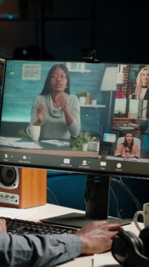 Dikey Afrikalı Amerikalı uzaktan kumandalı işçi oturma odasındaki bir web görüşmesine katılıyor. Gülümseyen siyah adam, İçişleri Bakanlığı 'nın yürütme konularını tartışmak için sanal iletişim kuruyor.