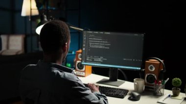 Programlama ve veri analizi için bilgisayarı kullanan Afrika kökenli Amerikalı bir uzman. Evinde çalışan genç ağ uzmanı, bilgi teknolojisi ve veri merkezini yönetiyor. Kamera A.