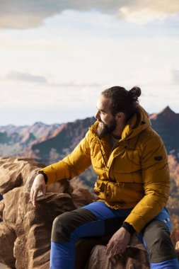 Maceraperestler önlerindeki vadiye ve dağ zirvelerine bakar. Açık arazinin özgürlüğünü hisseder. Genç kaşif tam donanımlı yüksek rakımlı açık hava keşiflerinin tadını çıkarıyor..