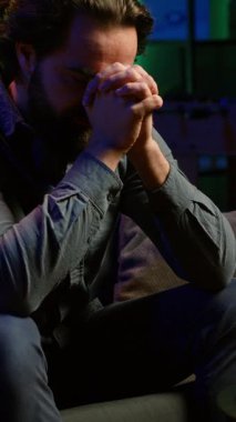 Dikey video Destekçisi canlı yayında spor maçı izliyor ve takım performansına kızıyor. Futbol müsabakasına bakan kızgın bir adam, oyuncuların kaçırdığı bir şansı kaçırdığı için öfkeli.