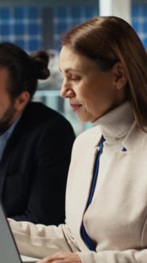 Dikey video fabrikası yöneticisi evrak dosyalarına bakıyor, iş modelini geliştiriyor, üretimi arttırıyor. Çalışan belgeleri okuyor, otomasyon teknolojisini endüstriyel teknolojiye entegre ediyor