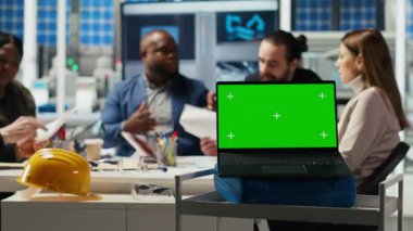 Fotovoltaik fabrikasının hissedarları yatırım stratejisini belirlemek için yeşil ekran dizüstü bilgisayardaki pazar eğilimlerini analiz ediyorlar. Yöneticiler krom anahtar defteri, genişleyen fabrika üretimi, kamera B 'deki verilere bakarlar.