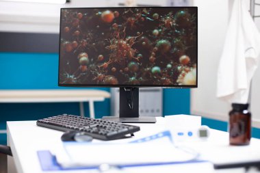 Biyolojik araştırmalarda kullanılan teknolojiyi vurgulayarak grip hastalığıyla ilgili hücresel yapıları gösteren bilgisayar ekranına yakın çekim. Modern masaüstü bilgisayar kliniği ofis masası viral hücrelerin görüntüsünü gösterir.