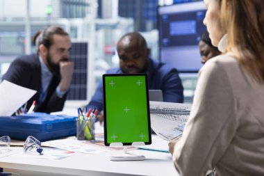 Photovoltaics fabrikası yatırımcıları izole ekran tableti kullanarak verileri analiz ediyor, sistem sağlık ölçümlerini gözden geçiriyorlar. Güneş panelleri, teknik sorunları modelleme aygıtı kullanarak gideren yöneticiler yerleştiriyor