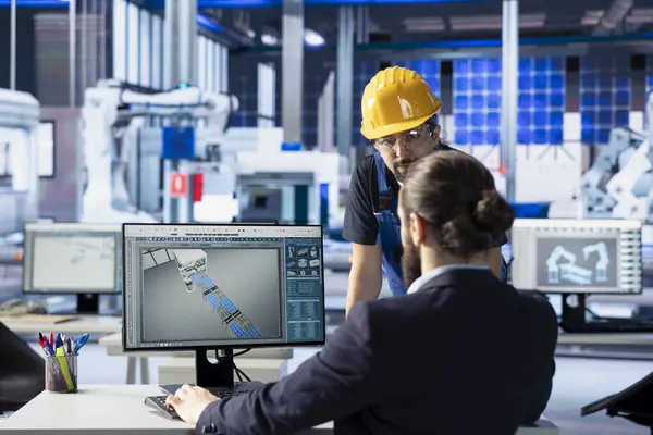 Fotovoltaik fabrika mühendisliği ekibi güneş paneli tasarımlarını test ediyor. Mevcut güneş paneli konfigürasyonlarını maliyet azaltma için geliştiren takım arkadaşları