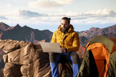 Doğayı seven işkolik her zaman internete bağlanır ve dizüstü bilgisayarda kayar, nefes kesen manzaralı dağın tepesinde güçlü bir sinyalin tadını çıkarır. Kesintisiz çalışma.